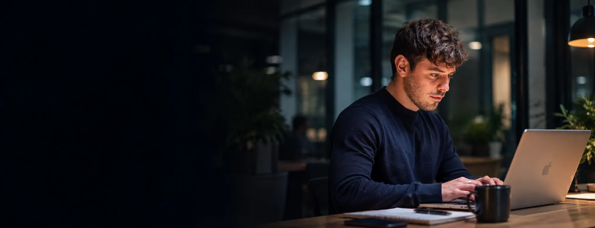 A man working at a laptop in an office